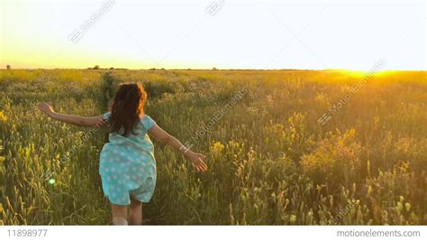 Beauty Girl Running On Green Wheat Field Over Sunset Sky Freedom