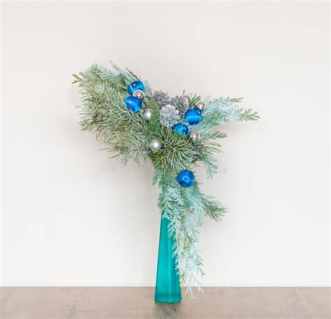 Decorative Christmas Arrangement With Pine Branches In A Blue Vase