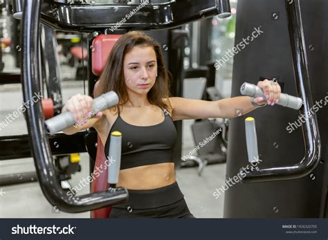 Young Fit Woman Trains Pectoral Muscles Stock Photo 1926320705