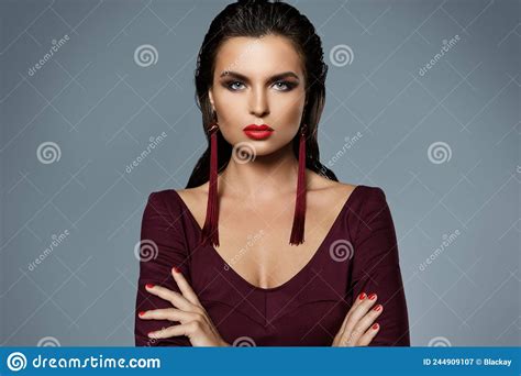 stunning woman with a beautiful makeup wearing long red earrings stock image image of nails