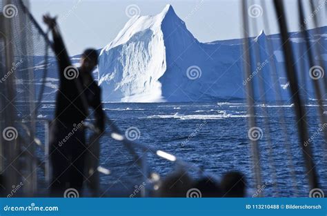 Silhouette Of A Men In Front Of A Huge Iceberg Stock Photo Image Of