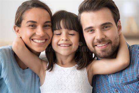Cute Little Daughter Embracing Parents Mom And Dad Headshot Por Stock