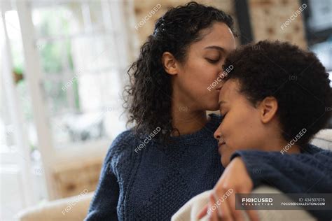 Mixed Race Lesbian Couple Kissing On Forehead In Kitchen Self