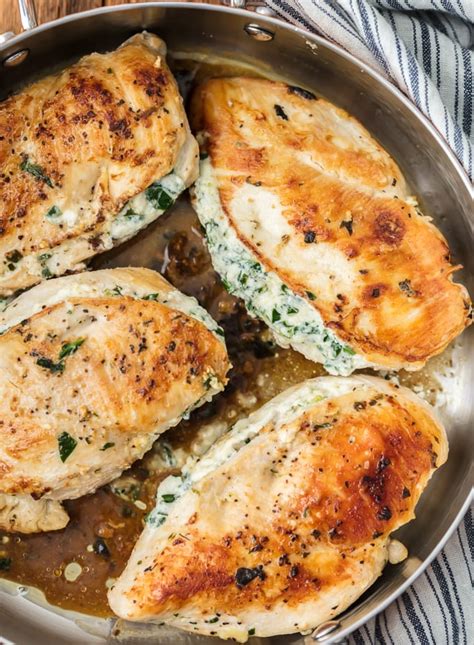 The breast is stuffed with cheese, breaded and baked in tomato sauce. 3 Ingredient Spinach Dip Stuffed Chicken - Cravings Happen