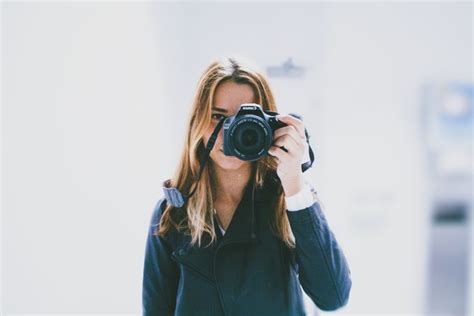 Woman Holding Camera To Take Picture Stock Photo Free Download