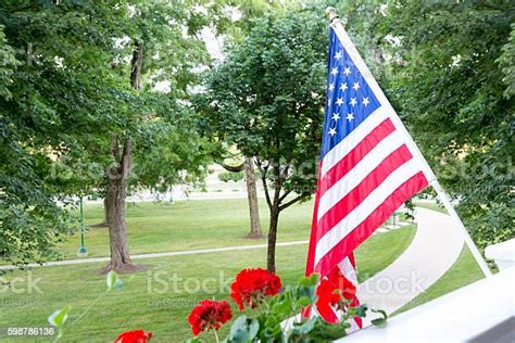 American Flag Flying From A Balcony Or Patio Stock Photo Download