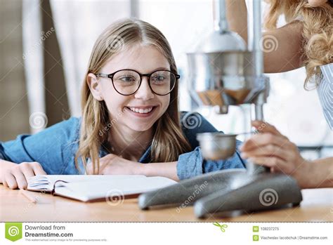 Portrait Of Smiling Girl That Looking At Kitchen Gadget Stock Image