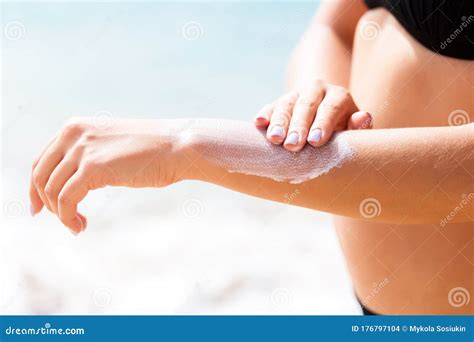 Pretty Girl Is Putting Sun Lotion On Her Hand At The Beach Stock Photo Image Of Spread