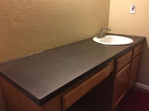 Concrete countertops are just one of the many kitchen countertop options to choose from. Customs dark brown concrete countertop with a white ...