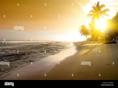 Orange Sky Over Ocean And Sandy Beach Stock Photo Alamy