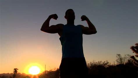 Silhouette Of Man Flexing Muscles Stock Footage Video 100