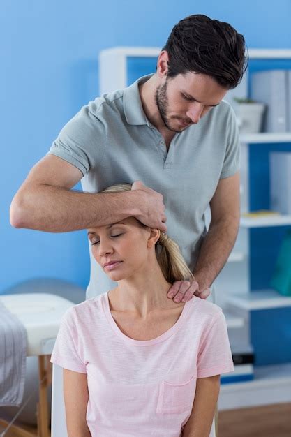 Premium Photo Physiotherapist Stretching Neck Of A Female Patient