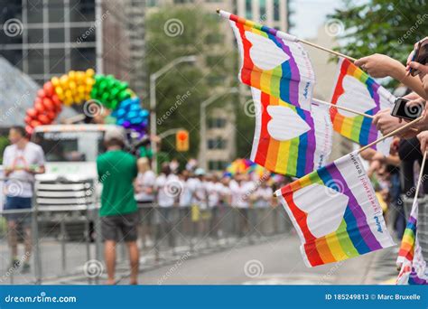 gay pride parade spectators holding gay rainbow flags during toronto pride parade in 2017