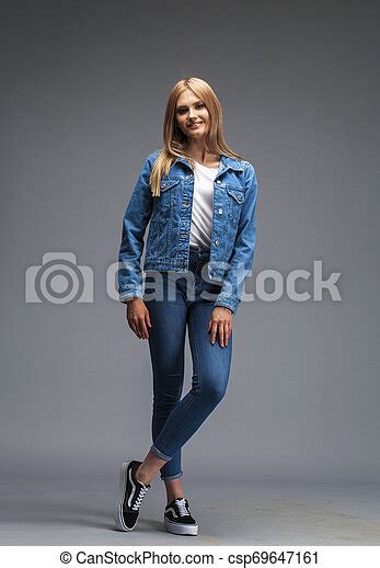 Beautiful Sexy Blonde Woman Dressed In A Denim Jacket And Blue Jeans Fashion Model In Jeans