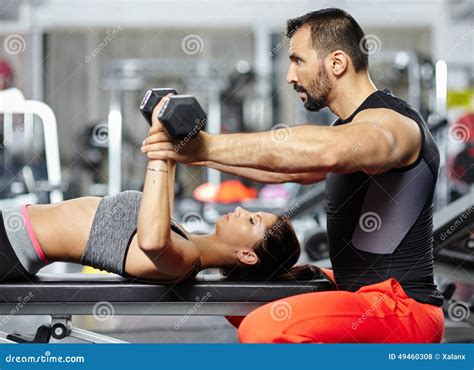 Personal Trainer Assisting Young Woman Stock Photo Image Of Help