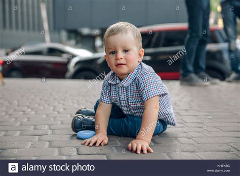Little Babyboy Sitting On The Sidewalk Stock Photo Alamy