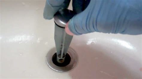 The weight and pressure of the water may clear the stoppage. Replacing a broken pop-up drain assembly - YouTube