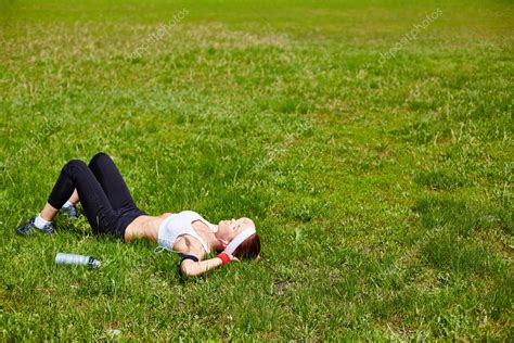 Woman Relaxing On Green Lawn Stock Photo By Pressmaster