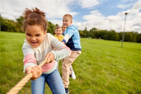 Happy Children Playing Tug Of War Game At Park Stock Image Image Of