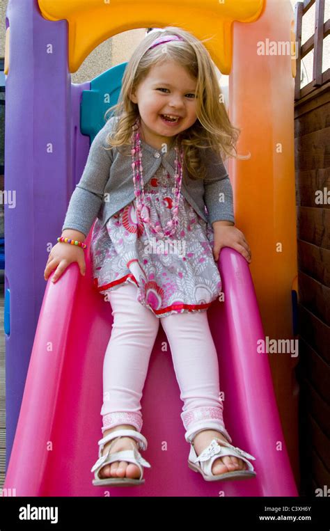 Vertical Portrait Of A Cute Little Girl Having Fun Playing On A