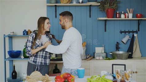 Cheerful And Attractive Young Couple In Love Dancing Together Latin Dance In The Kitchen At Home