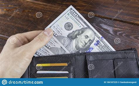 Most credit card statements show the daily periodic rate or the daily interest rate. The Hand Takes Cash Dollars From A Wallet With Credit Cards To Calculate Or Pay For Services ...