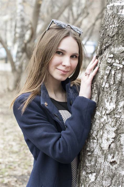 The Beautiful Russian Woman Sits On A Bench In The Park Stock Image Image Of Spring