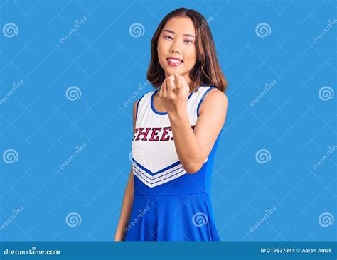 Young Beautiful Chinese Girl Wearing Cheerleader Uniform Beckoning Come