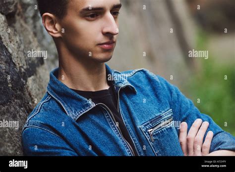 Brooding Young Guy In Denim Walks On The Street Stock Photo Alamy