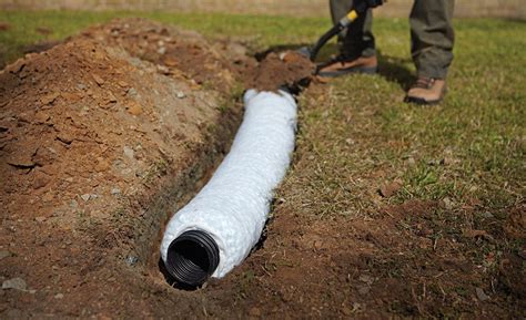 A Person Installing A Gravel Free French Drainage System French Drain Installation Landscape