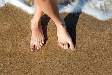Woman S Bare Feet On Sandy Beach Stock Photo Dissolve