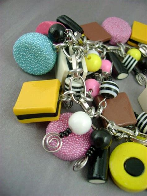 A Close Up Of A Bunch Of Different Items On A Chain Bracelet With Beads