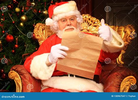 Portrait Of Happy Santa Claus Sitting At His Room At Home Near