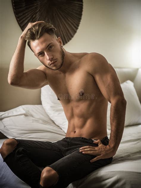shirtless male model lying alone on his bed stock image image of home lying 132435337