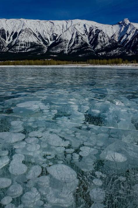 Vertical Crystal Clear Lake Abraham Is Surrounded By Snowy Canadian