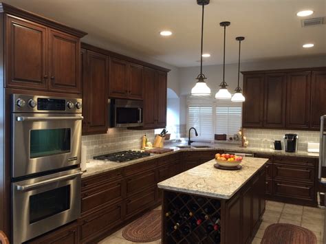 They are at the intersection of fm1960 and kuykendahl roads. Bright kitchen featuring dark stained cabinets with light gray accents - Traditional - Kitchen ...