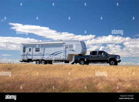 A Truck Pulling A Camper Trailer On The Highway Stock Photo 4739373