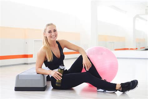 Happy And Smiling Woman Drinking Water After Aerobics Workout Stock