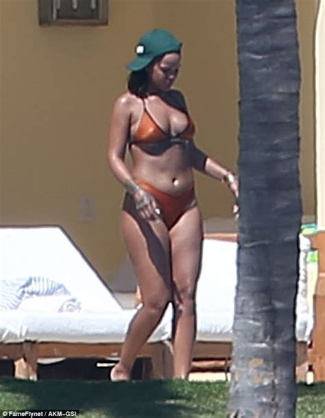 rihanna shows off her body in bikini and erm she looks good but different photos