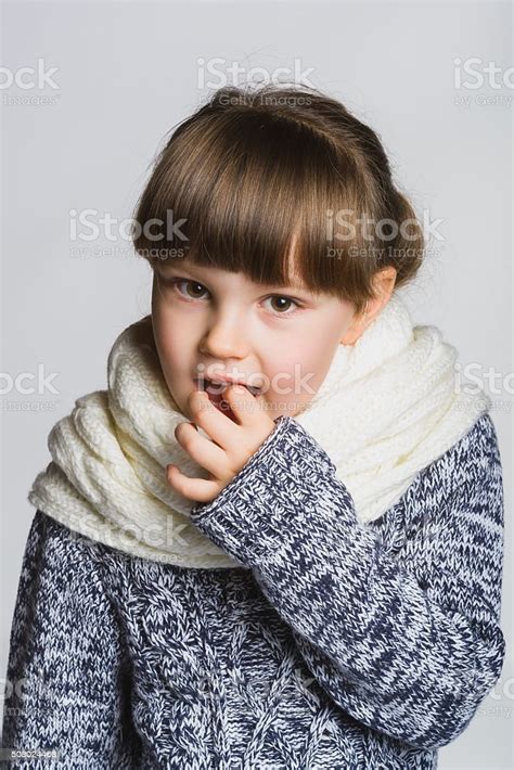 Girl Holding A Finger In The Mouth Close Up Female Stock Photo