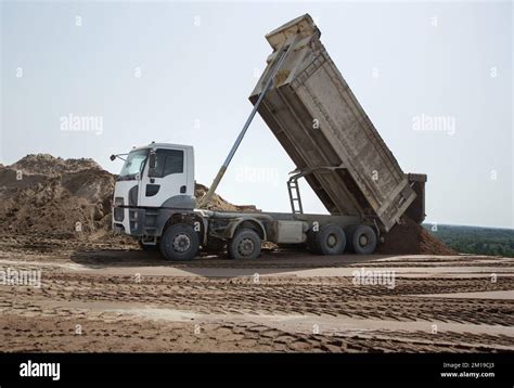 Gray Dump Truck At The Construction Site In The Process Of Transporting