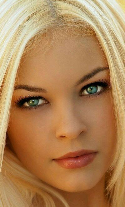 A Woman With Long Blonde Hair And Green Eyes