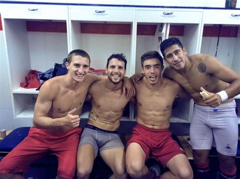 Four Shirtless Men Are Posing For A Photo In The Locker Room With Their