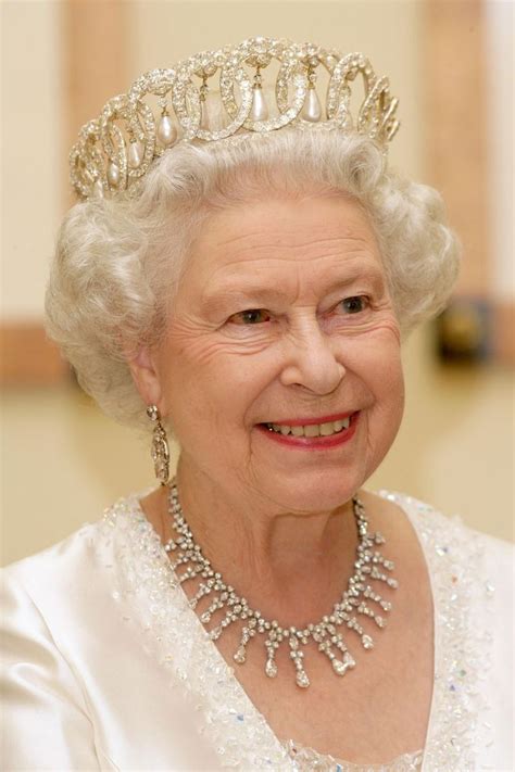 An Older Woman Wearing A Tiara And Smiling