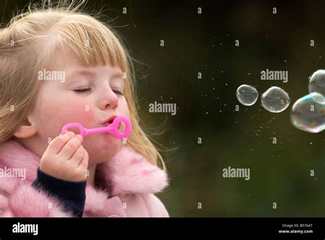 Girl Blowing Bubbles Stock Photo Alamy