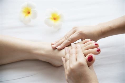 Free Photo Woman Receiving Foot Massage Service From Masseuse Close Up At Hand And Foot