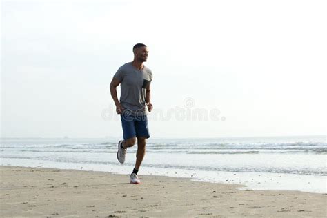 Young African Man Jogging At The Beach Stock Photo Image Of Jogging