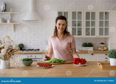 Happy Beautiful Young Housewife Woman Cooking Dinner In Kitchen Stock