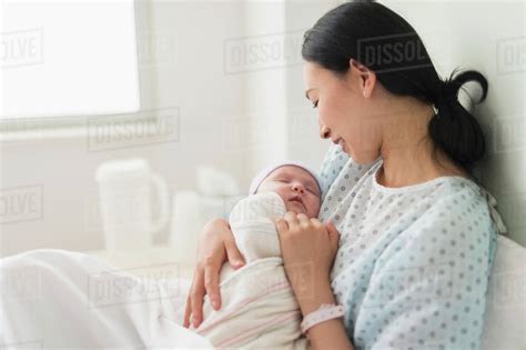 Asian Mother Holding Newborn Baby In Hospital Stock Photo Dissolve