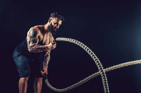 Premium Photo Muscular Man Working Out With Heavy Rope Photo Of Man With Naked Torso Strength